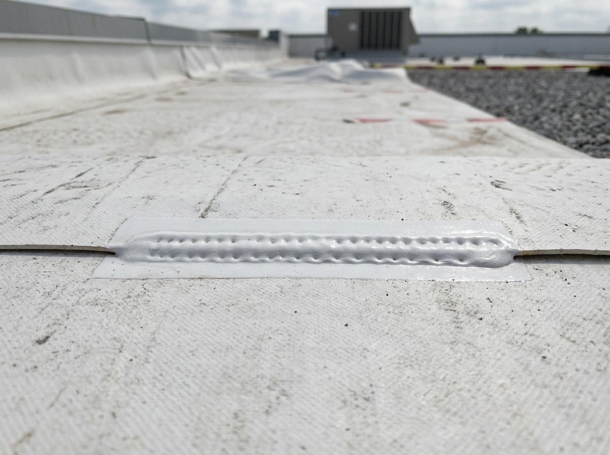 Heat-welded TPO membrane seam on a finished commercial roof in Panama City, FL