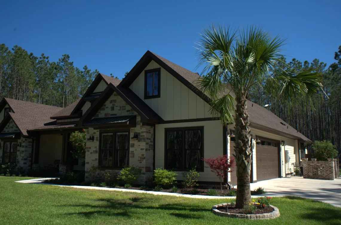 New residential roof installation on two-story home with stone and stucco exterior in Tallahassee