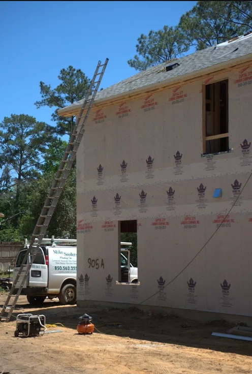 Residential roof replacement in progress with new sheathing and underlayment visible