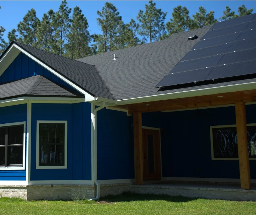 Modern home with new gray asphalt shingle roof and solar panels installed