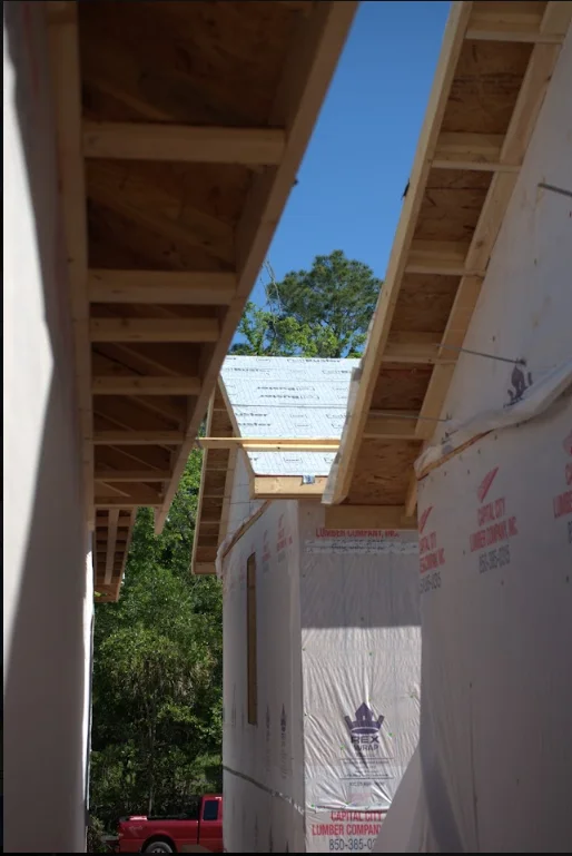 Wooden roof trusses and beams during residential framing construction in Tallahassee