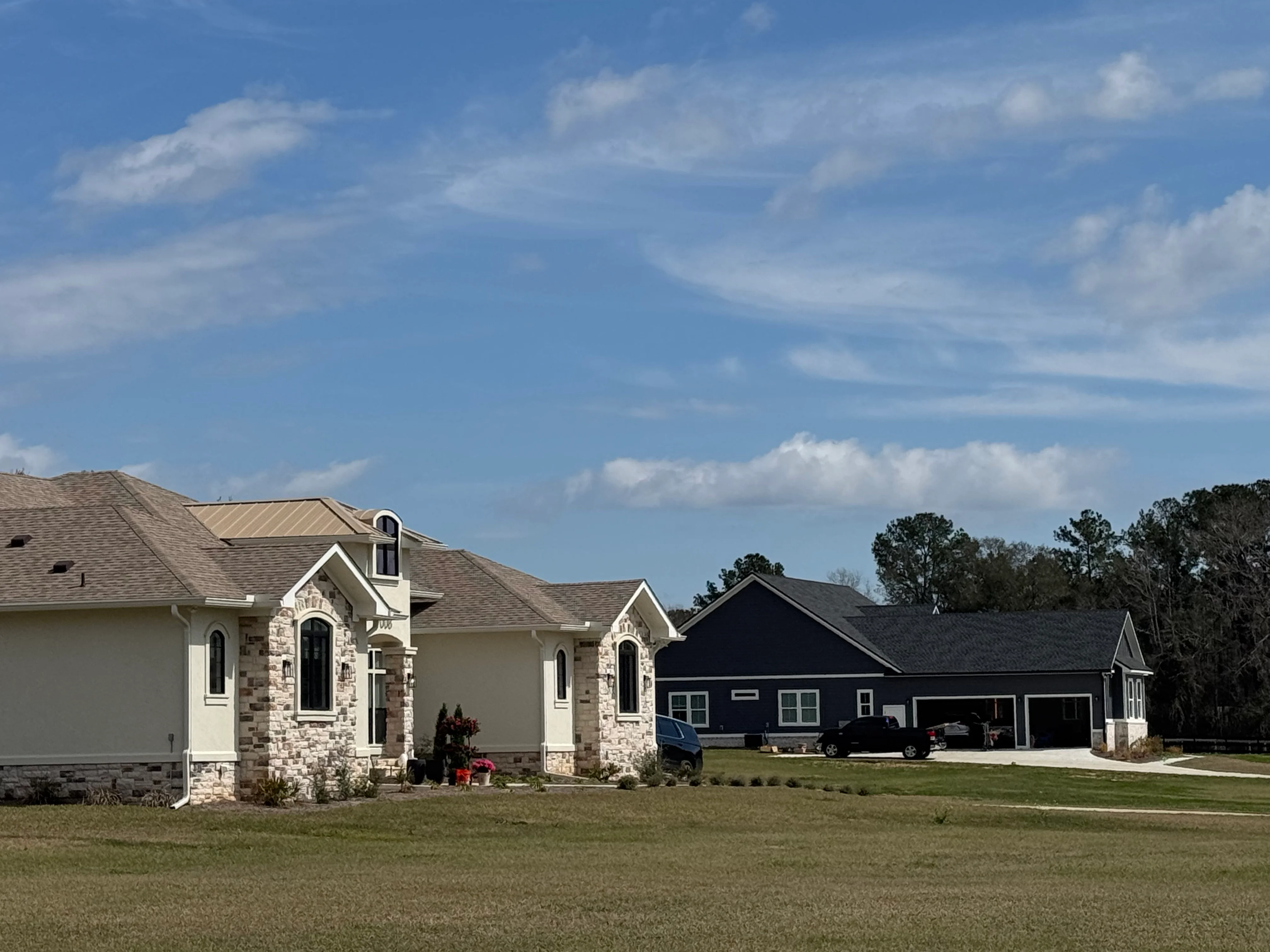 New residential home with gray and tan architectural shingle roofing installation