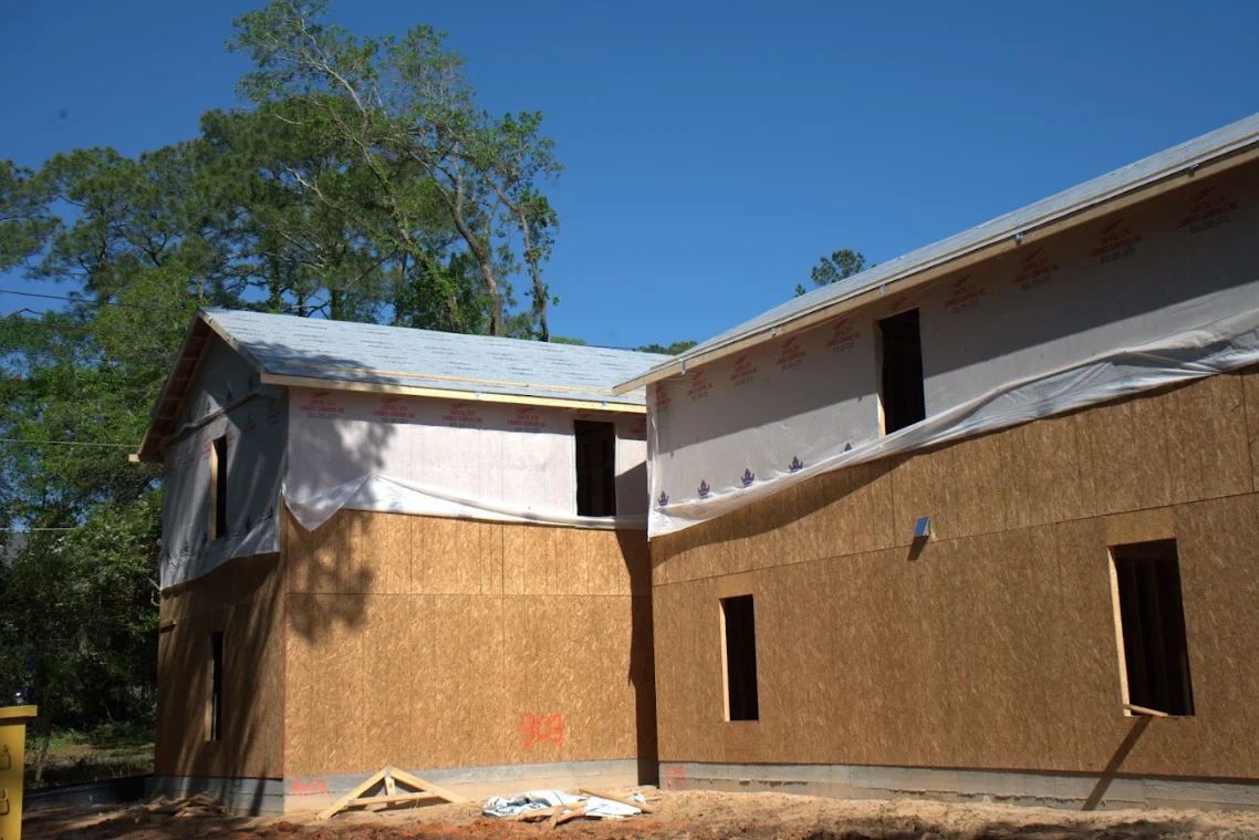 New residential roof framing with metal roofing and OSB sheathing under construction